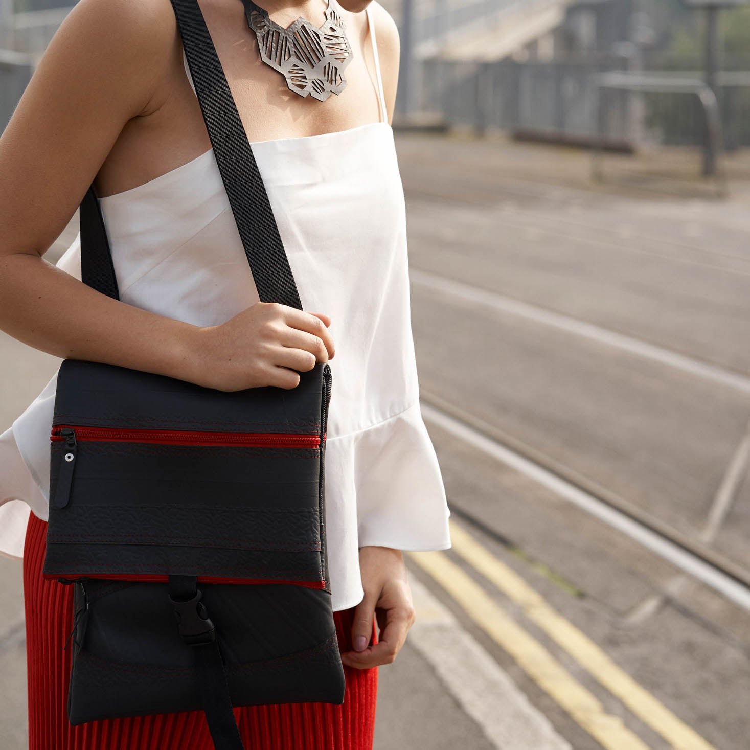 Paguro Upcycle recycled rubber crossbody bag featuring a stylish design and adjustable strap