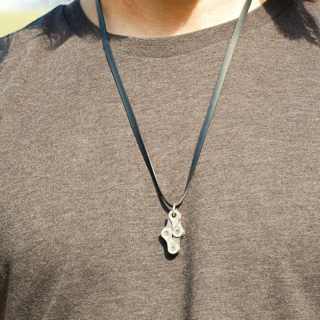 Paguro Upcycle recycled bike chain necklace pendant on black leather cord worn on chest