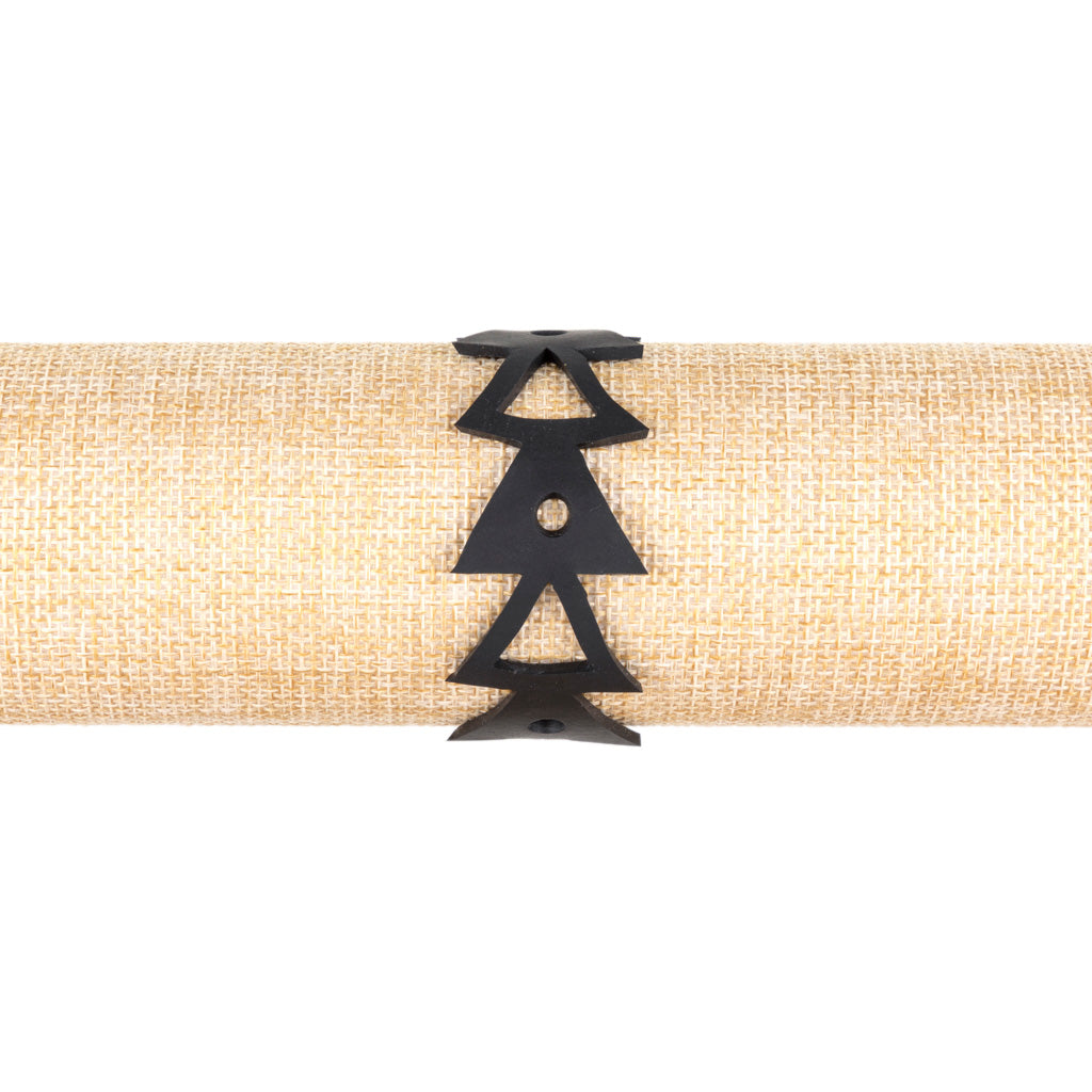 Paguro Upcycle black upcycled rubber bracelet with geometric triangle design on burlap display